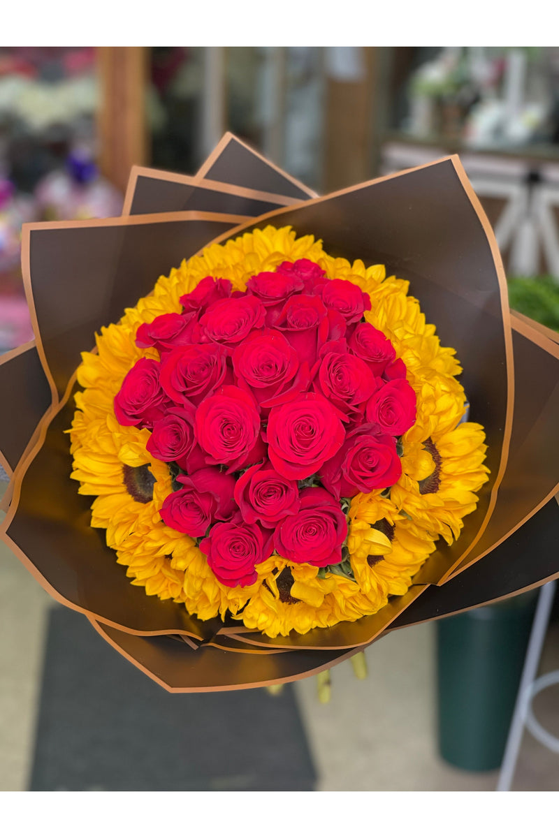 Rose and sunflower bouquet with vibrant red roses surrounded by golden sunflowers – Eclore Floral NJ