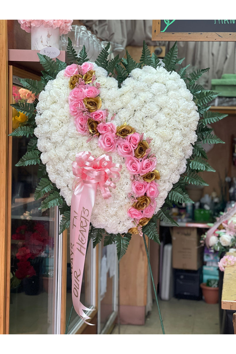 Artificial white carnation heart with curved pink and gold roses on standing easel – funeral sympathy arrangement by Eclore Floral NJ