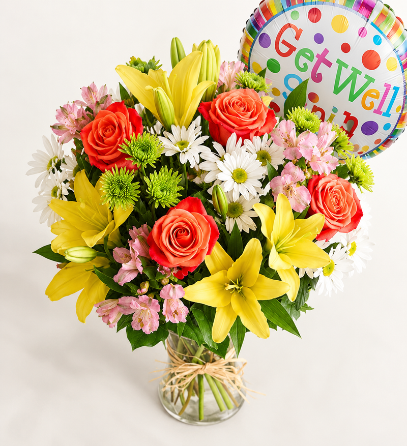 Elevated view of colorful get well flowers in a glass vase with raffia bow and Get Well balloon