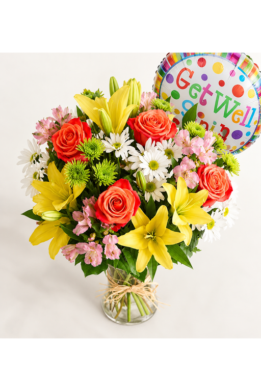 Elevated view of colorful get well flowers in a glass vase with raffia bow and Get Well balloon