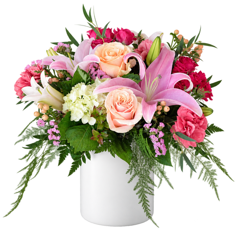 Pink lily and peach rose flower arrangement in a solid white ceramic vase
