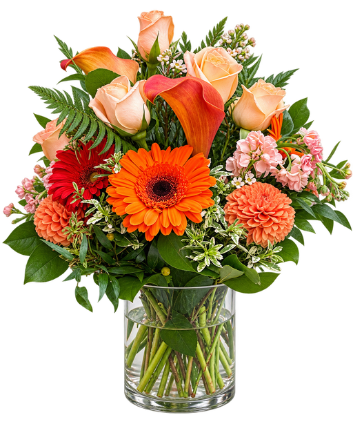 Rustic Flame orange flower arrangement with peach roses, orange gerbera daisies, calla lilies and dahlias in a clear glass vase