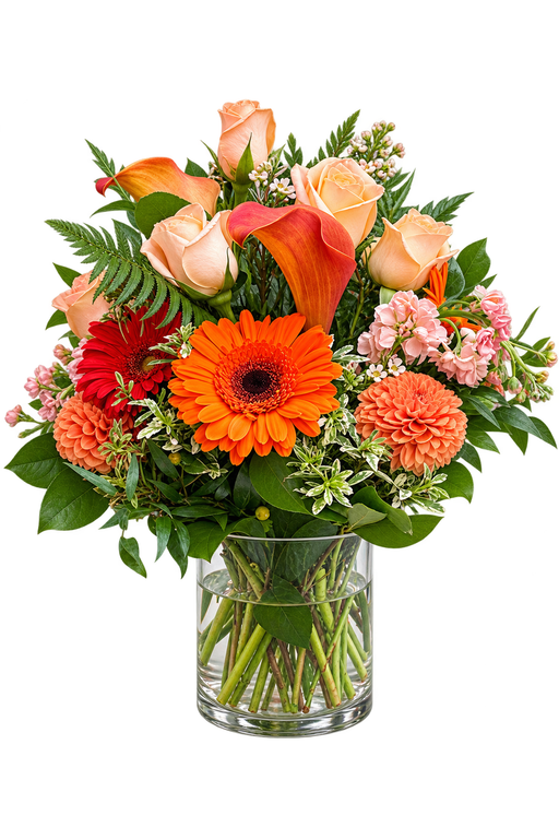Rustic Flame orange flower arrangement with peach roses, orange gerbera daisies, calla lilies and dahlias in a clear glass vase