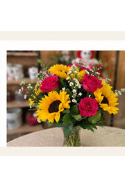 Sunshine Garden sunflower and rose arrangement shown from a natural three-quarter angle.