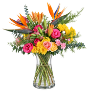 Tropical Radiance flower arrangement with Birds of Paradise, roses, lilies and yellow chrysanthemums in a clear glass vase