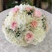 White Stripes pink rose and white hydrangea arrangement viewed from above.