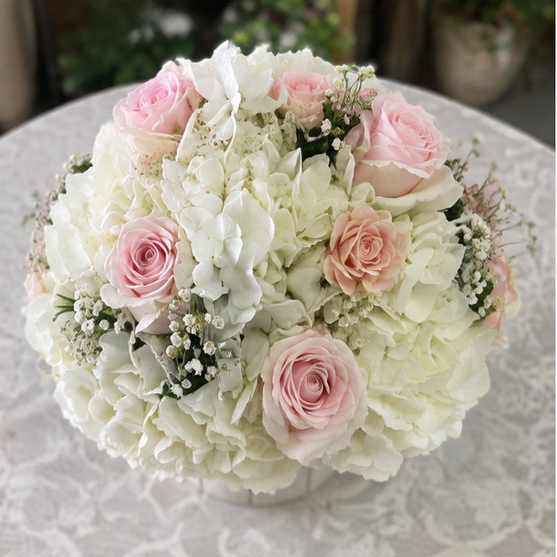 White Stripes pink rose and white hydrangea arrangement viewed from above.