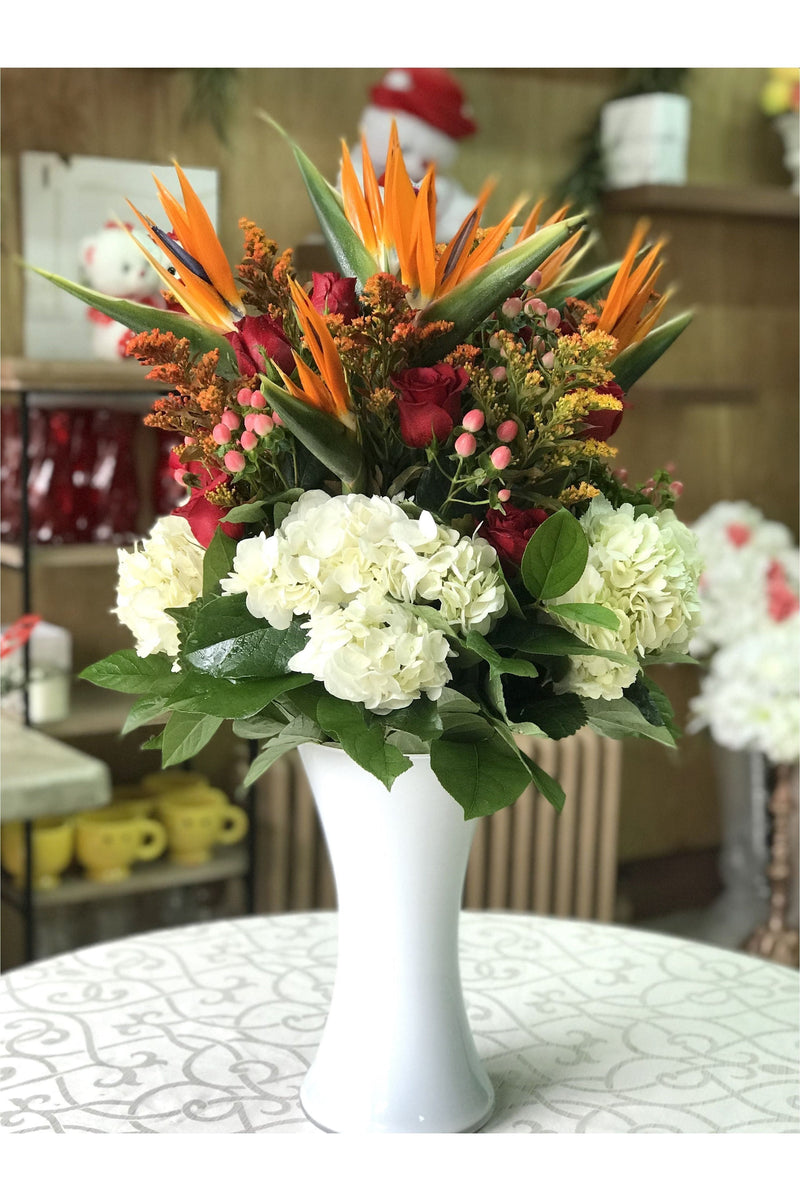 Birds of Paradise and rose flower arrangement with white hydrangeas in a tall vase – New Jersey florist.