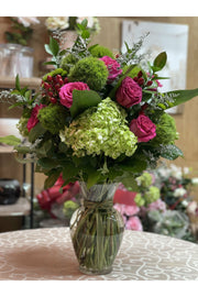 Green Brew floral arrangement with green hydrangeas, pink roses, moss balls, and berries in a clear vase — Eclore Floral Hackensack NJ delivery