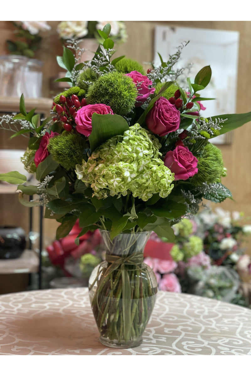 Green Brew floral arrangement with green hydrangeas, pink roses, moss balls, and berries in a clear vase — Eclore Floral Hackensack NJ delivery