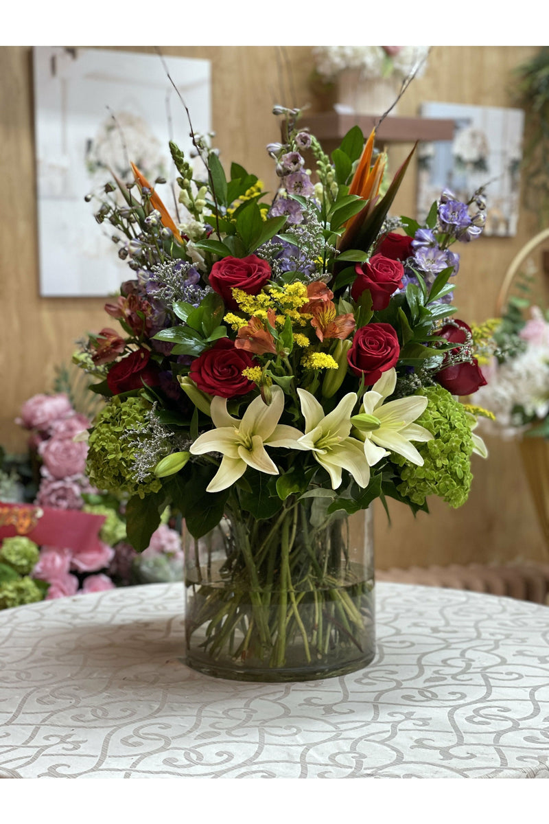 Sparkling Lily floral arrangement with lilies, red roses, hydrangeas, and Birds of Paradise in a clear vase — Eclore Floral Hackensack NJ delivery