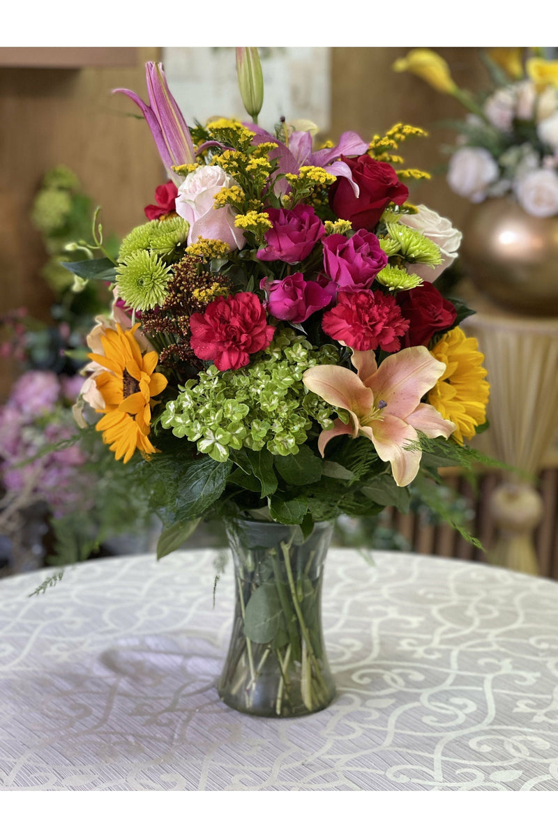 Bright sunflower and mixed-flower vase arrangement with lilies, roses, and hydrangeas – NJ same-day delivery.