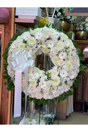 All-white funeral wreath with fresh white flowers, crafted for sympathy by Brooklyn florist.