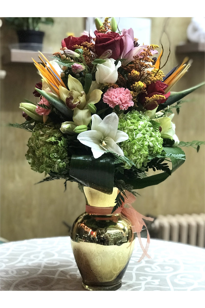 Luxury vase arrangement with green hydrangeas, lilies, roses, orchids, and tropical flowers designed by New Jersey florist.
