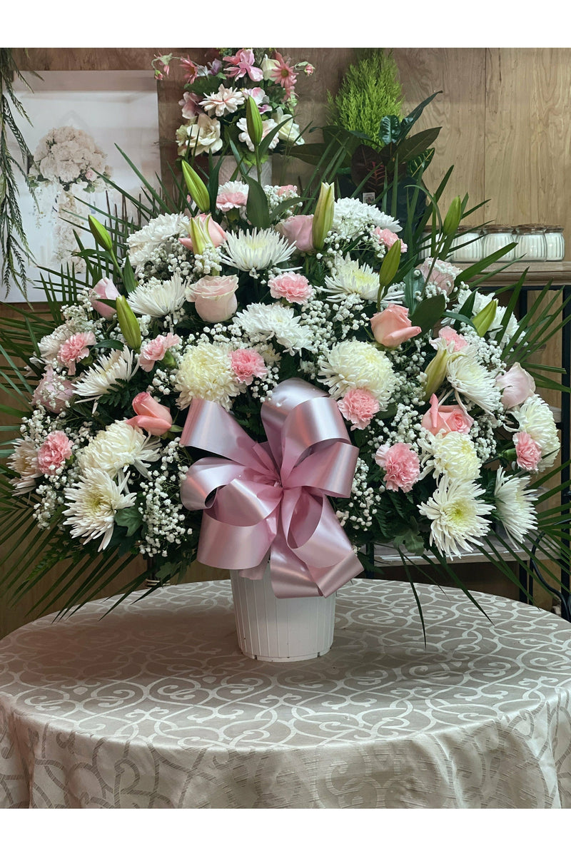 White and pink funeral flower basket with roses, carnations, and lilies — hand-delivered by Eclore Floral in Hackensack, NJ