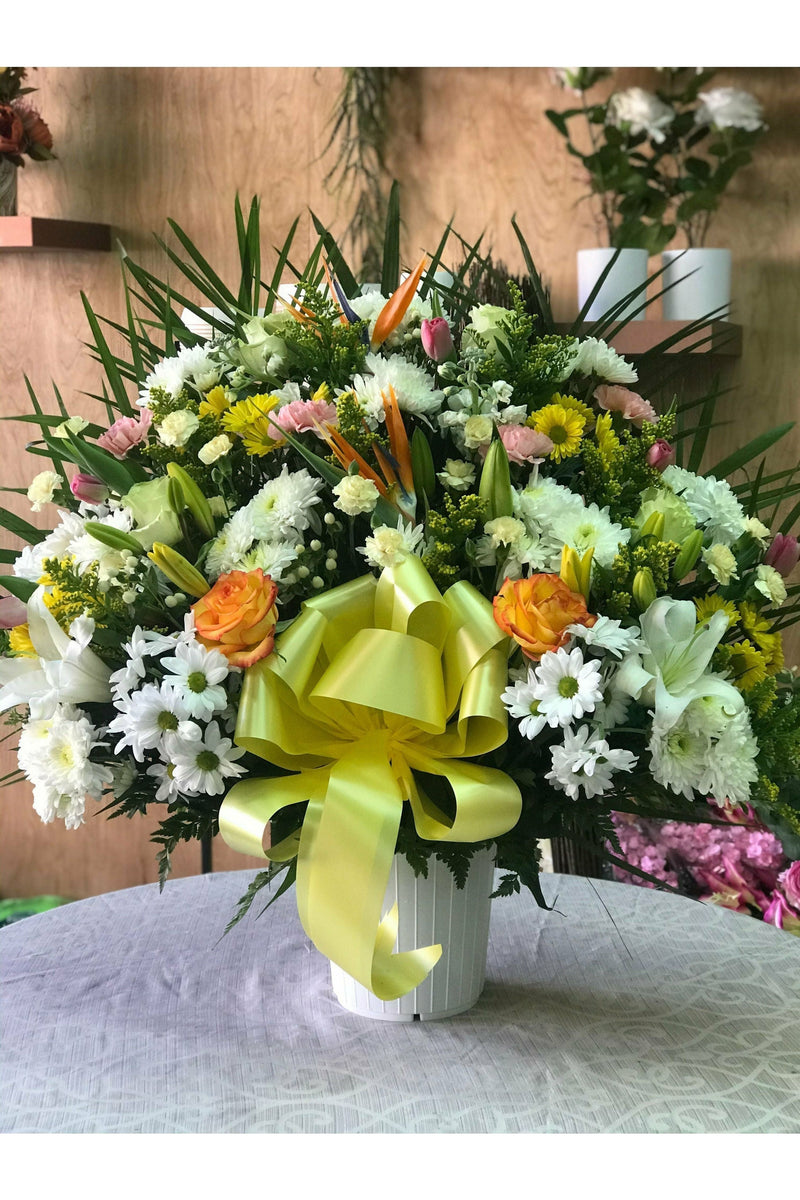 Multi-color sympathy flower basket with yellow, white, and orange blooms — handcrafted by Eclore Floral in Hackensack, NJ