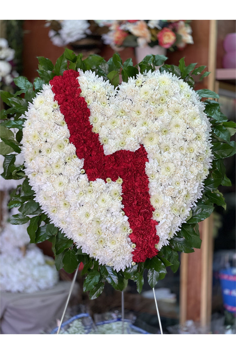Broken Heart funeral standing spray made with white chrysanthemums and red carnations