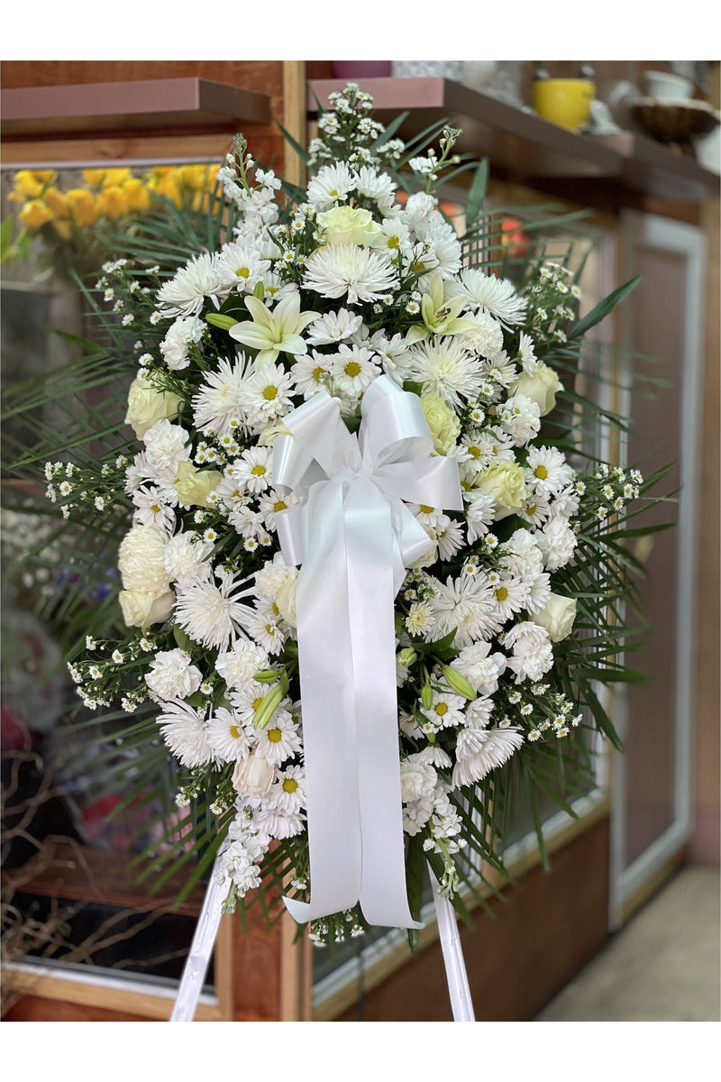 White funeral standing spray with roses, lilies, carnations, and mums – Hackensack NJ same-day delivery.