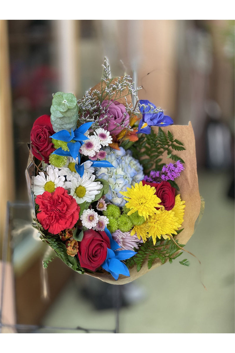 Colorful rainbow bouquet with mixed fresh flowers including roses, daisies, hydrangeas, and mums, wrapped in kraft paper – Eclore Floral NJ