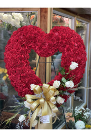 Red open heart funeral standing spray with red carnations, white roses, gold bow, and greenery – Eclore Floral NJ